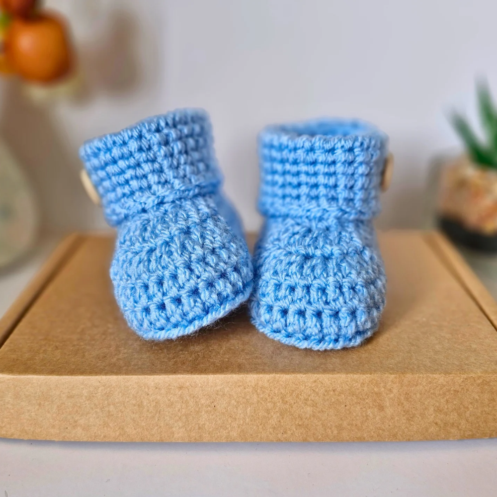 Handmade Born in 2025 Crochet Baby Booties – Handmade Keepsake Gift for Newborns – Baby Booties crafted in soft acrylic yarn and available in multiple colours by Twisted by the Sea.