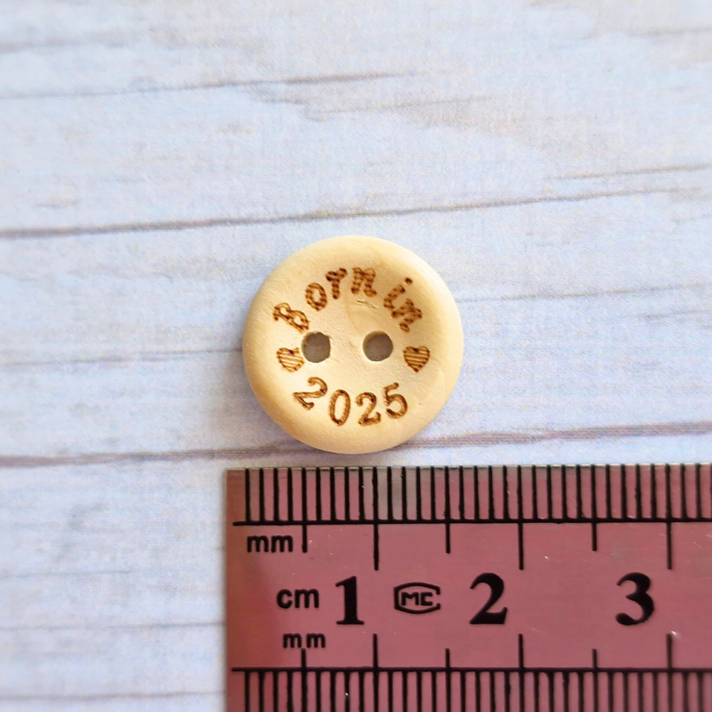 Handmade Born In 2025 Wooden Buttons – 15mm Natural Craft Buttons – Pack of 10, for Sewing, Knitting, Crochet – Buttons crafted in soft acrylic yarn and available in multiple colours by Twisted by the Sea.