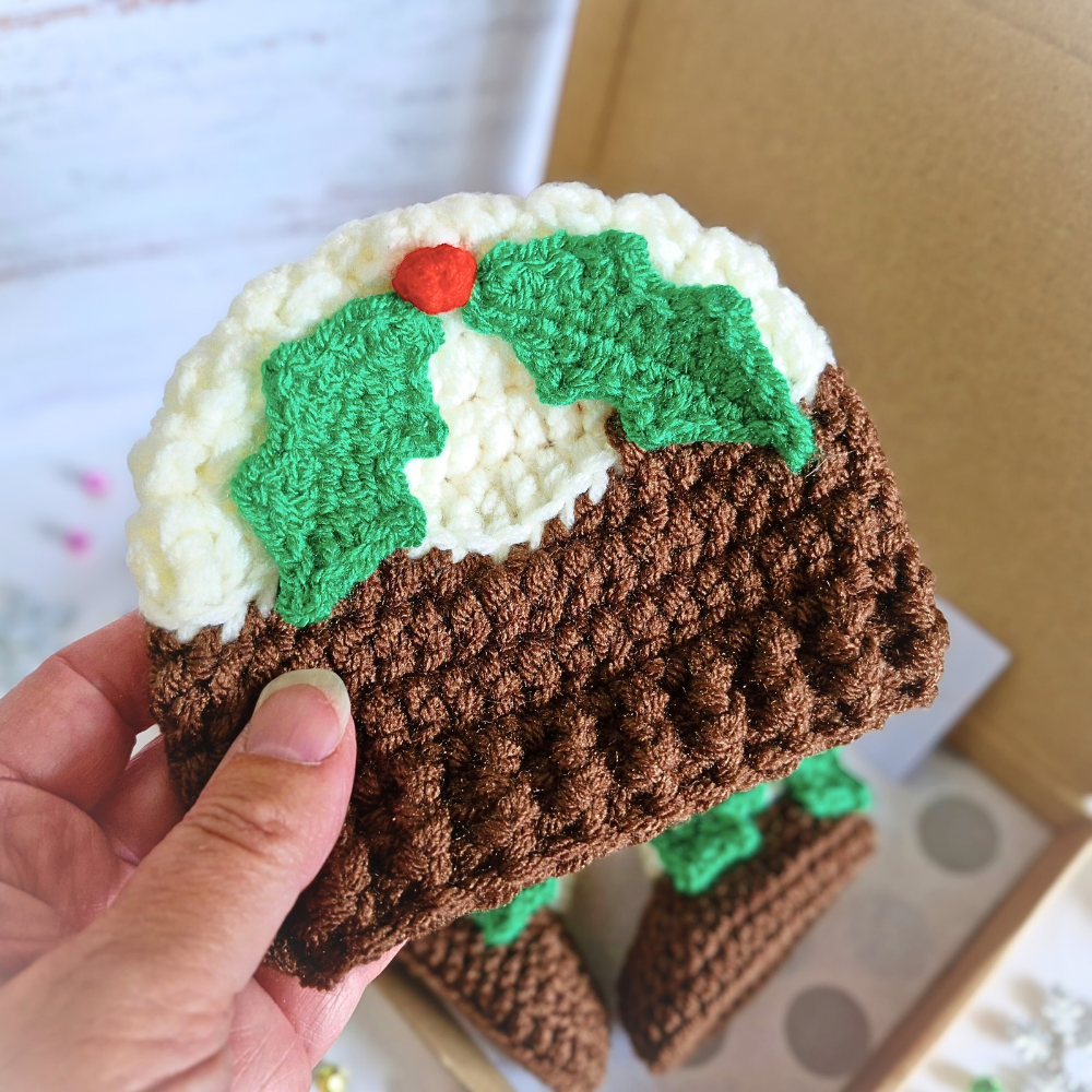Handmade Christmas Pudding Baby Hat with Holly & Berry – Beanie Hat crafted in soft acrylic yarn and available in multiple colours by Twisted by the Sea.