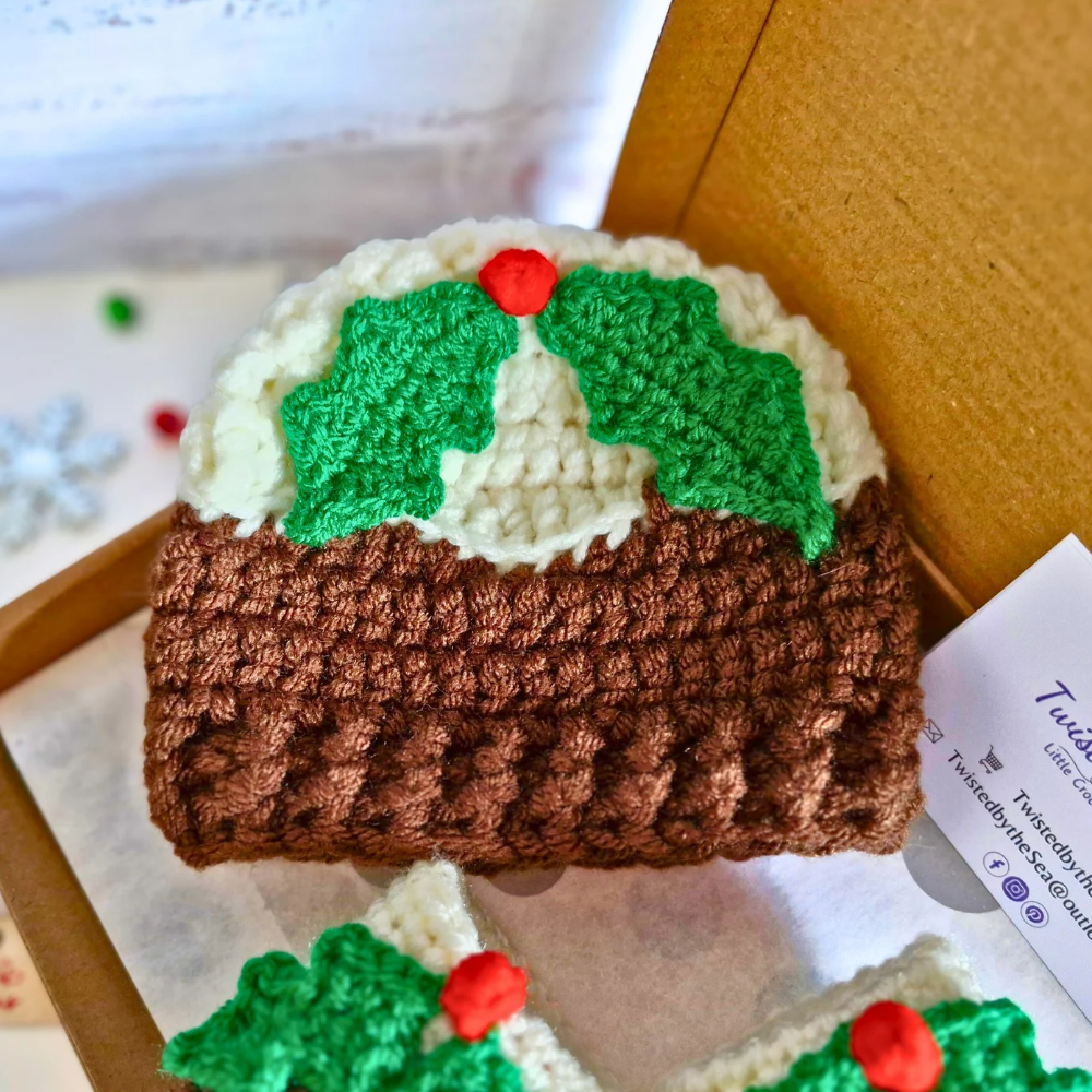 Handmade Christmas Pudding Baby Hat with Holly & Berry – Beanie Hat crafted in soft acrylic yarn and available in multiple colours by Twisted by the Sea.