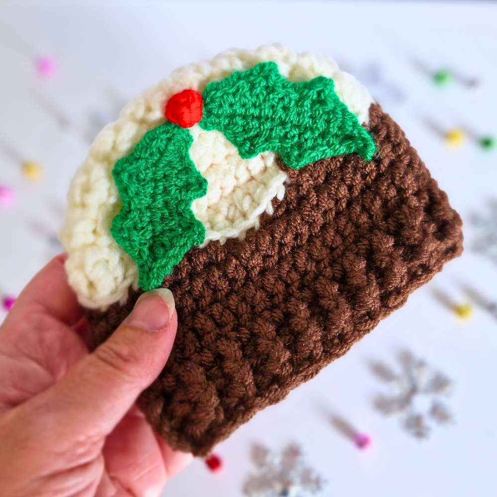 Handmade Christmas Pudding Baby Hat with Holly & Berry – Beanie Hat crafted in soft acrylic yarn and available in multiple colours by Twisted by the Sea.