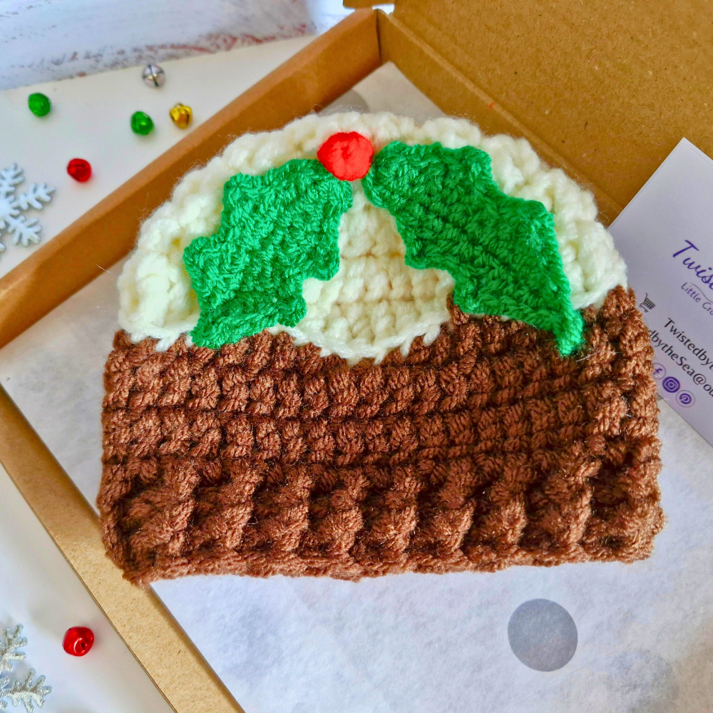 Handmade Christmas Pudding Baby Hat with Holly & Berry – Beanie Hat crafted in soft acrylic yarn and available in multiple colours by Twisted by the Sea.