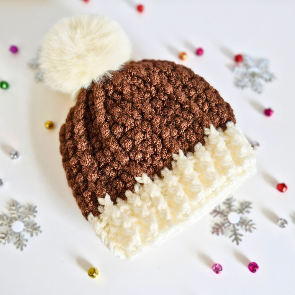 Handmade Christmas Pudding Baby Hat – Handmade Crochet Pom Pom Hat – Pom Pom Hat crafted in soft acrylic yarn and available in multiple colours by Twisted by the Sea.