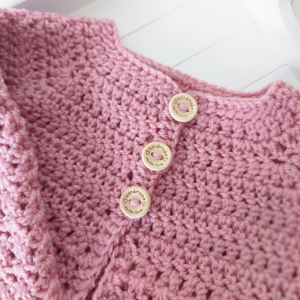 Handmade Crochet Daisy Baby Cardigan – Handmade in sizes 12 to 24 Months – Baby Toddler Cardigans crafted in soft acrylic yarn and available in multiple colours by Twisted by the Sea.