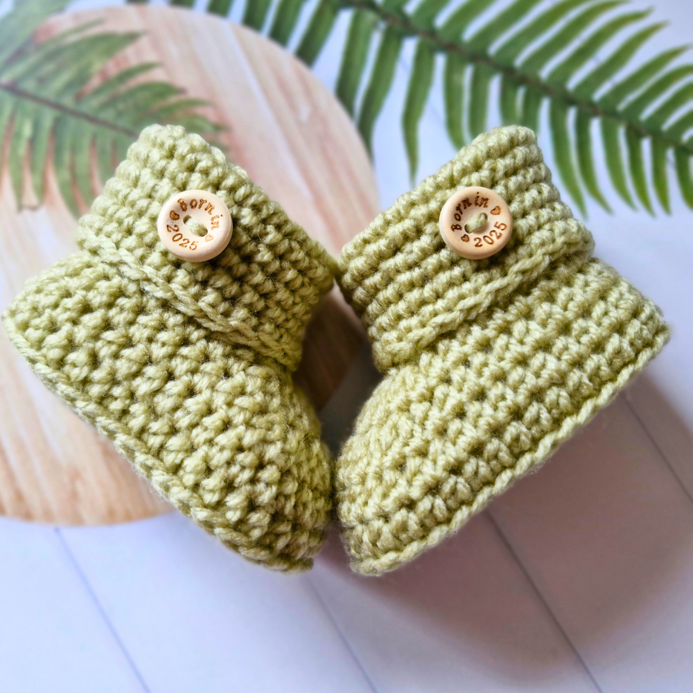 Handmade Born in 2025 Crochet Baby Booties – Handmade Keepsake Gift for Newborns – Baby Booties crafted in soft acrylic yarn and available in multiple colours by Twisted by the Sea.
