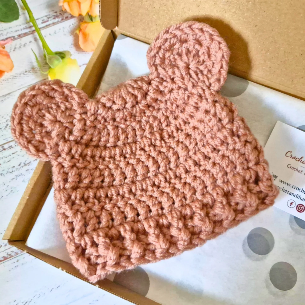 Handmade Handmade Crochet Teddy Bear Baby Hat – Cosy Newborn Beanie in Sizes to 6 Months – Beanie Hat crafted in soft acrylic yarn and available in multiple colours by Twisted by the Sea.