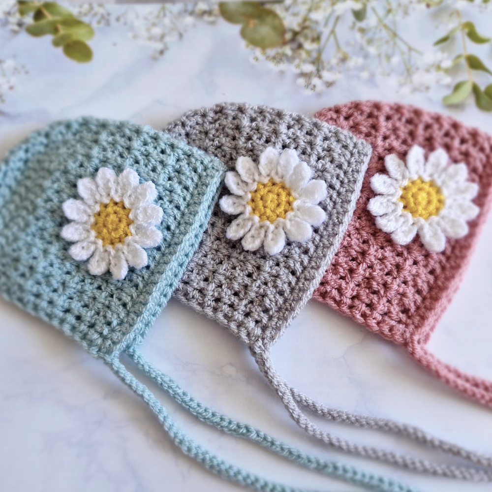 Handmade Handmade Crochet Daisy Baby Bonnet – Newborn to 12 Months – Beanie Hat crafted in soft acrylic yarn and available in multiple colours by Twisted by the Sea.