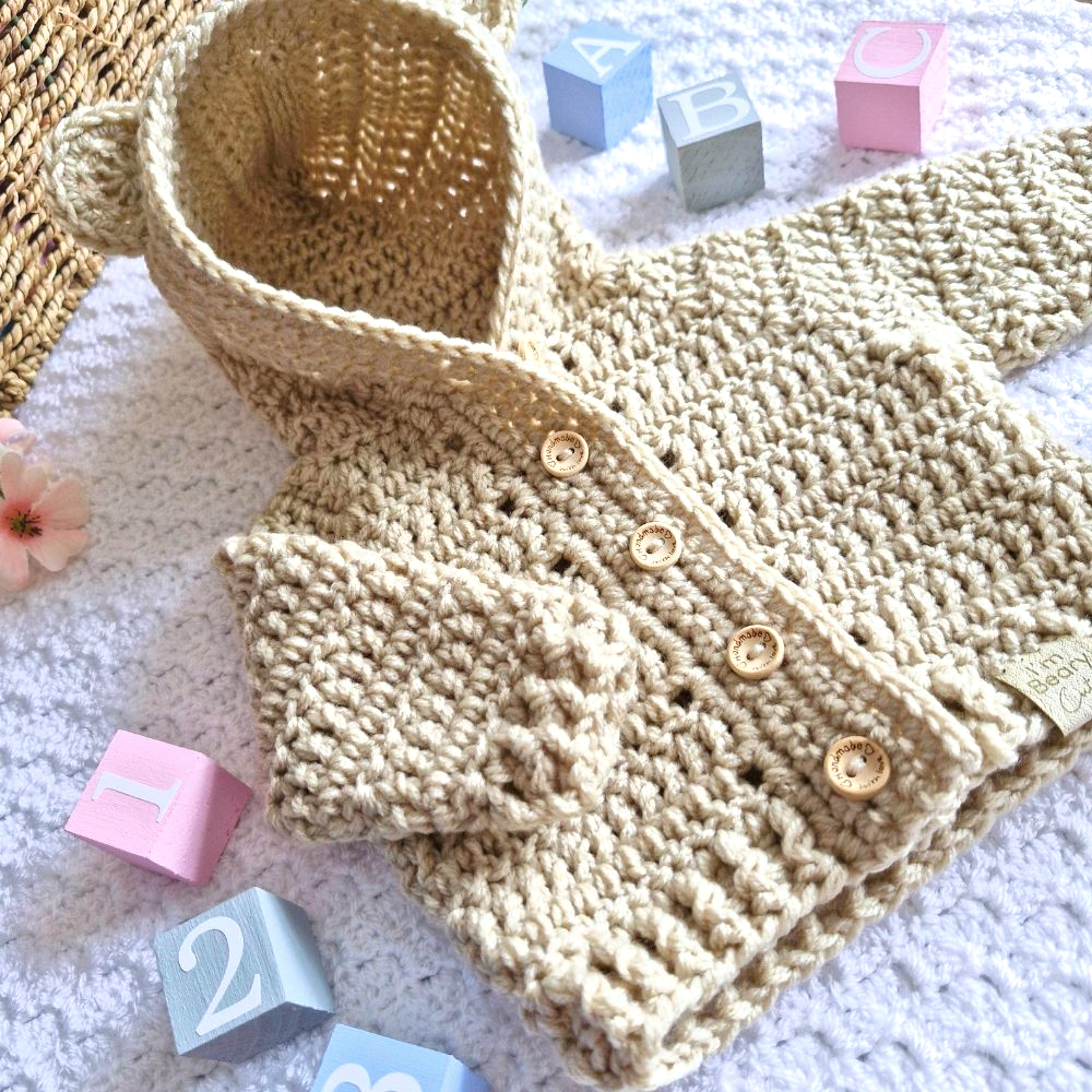 Handmade Crochet Baby Hooded Cardigan – Newborn to 12 Months – Baby Toddler Cardigans crafted in soft acrylic yarn and available in multiple colours by Twisted by the Sea.