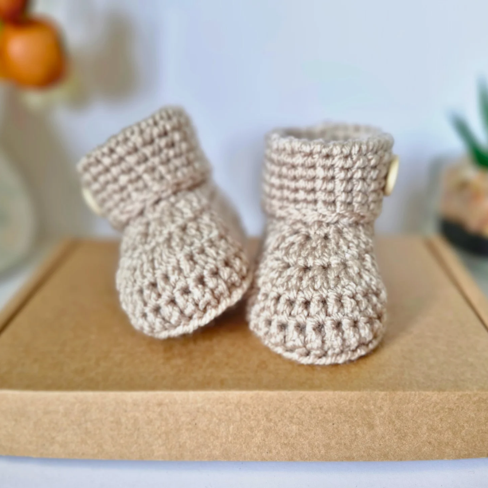 Handmade Born in 2025 Crochet Baby Booties – Handmade Keepsake Gift for Newborns – Baby Booties crafted in soft acrylic yarn and available in multiple colours by Twisted by the Sea.