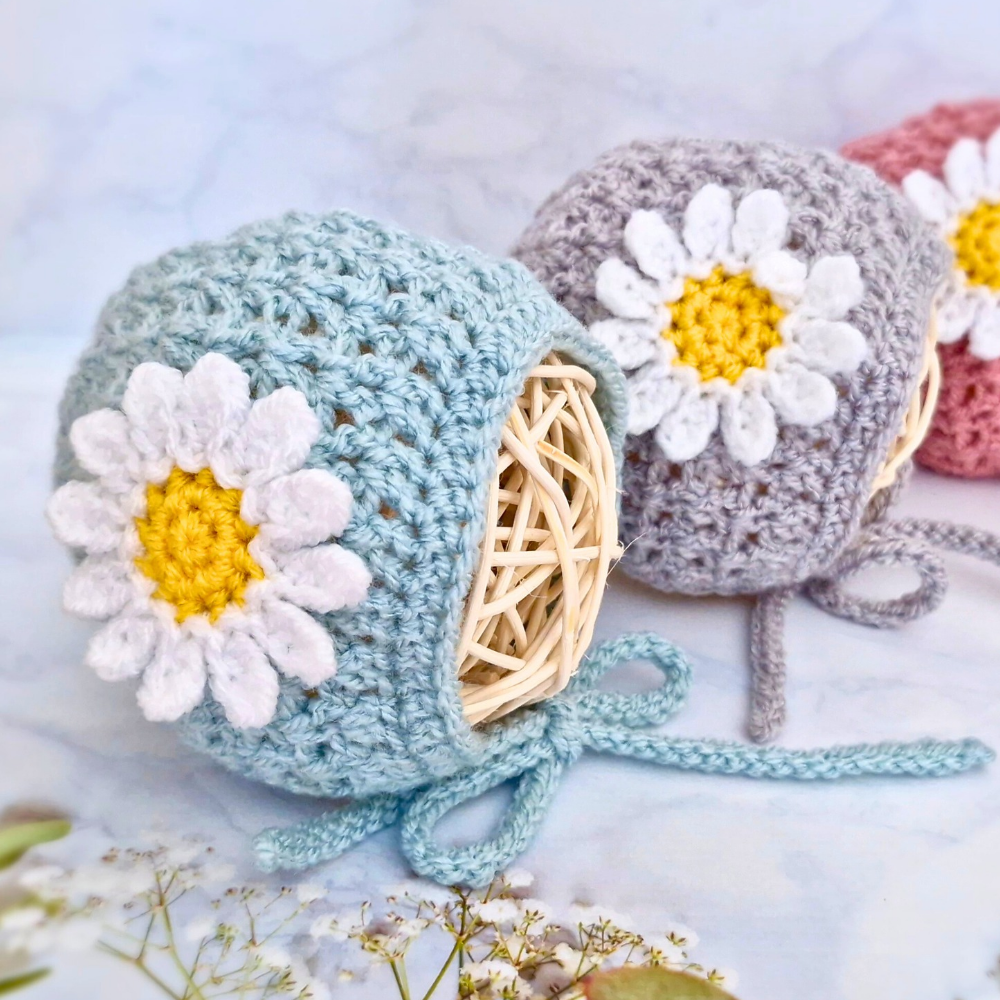 Handmade Handmade Crochet Daisy Baby Bonnet – Newborn to 12 Months – Beanie Hat crafted in soft acrylic yarn and available in multiple colours by Twisted by the Sea.