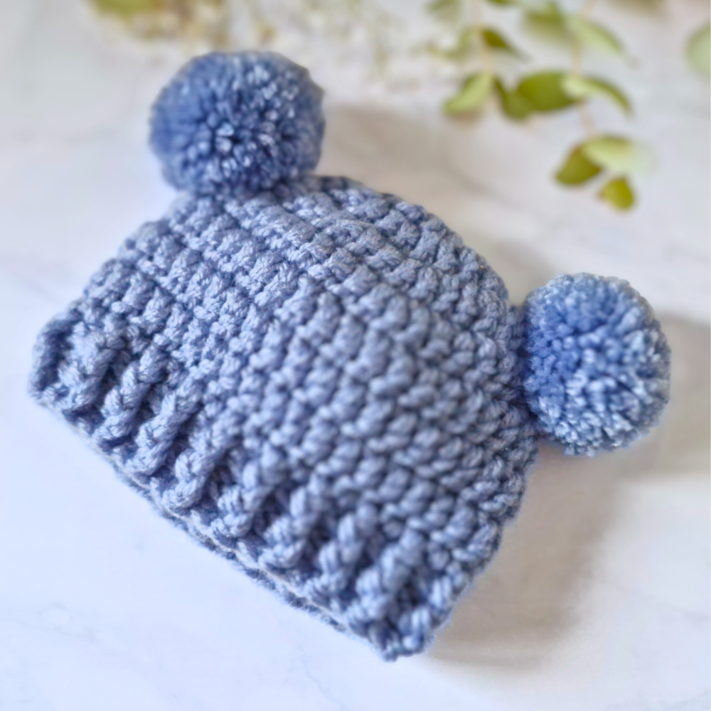 Handmade Handmade Crochet Double Pom Pom Baby Hat – Newborn to 12 Months – Beanie Hat crafted in soft acrylic yarn and available in multiple colours by Twisted by the Sea.