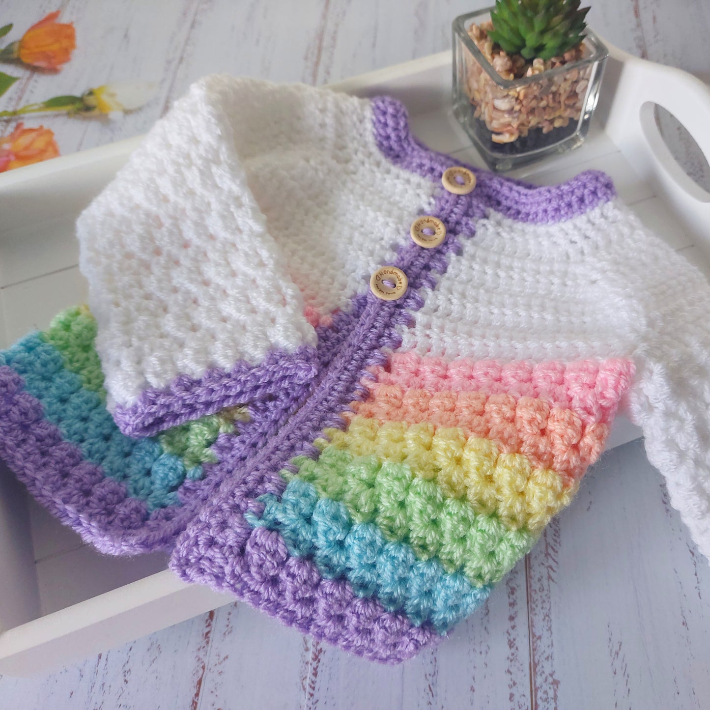 Handmade Handmade Crochet Rainbow Baby Cardigan – Sizes Newborn to 24 Months | Newborn Gift – Baby Toddler Cardigans crafted in soft acrylic yarn and available in multiple colours by Twisted by the Sea.