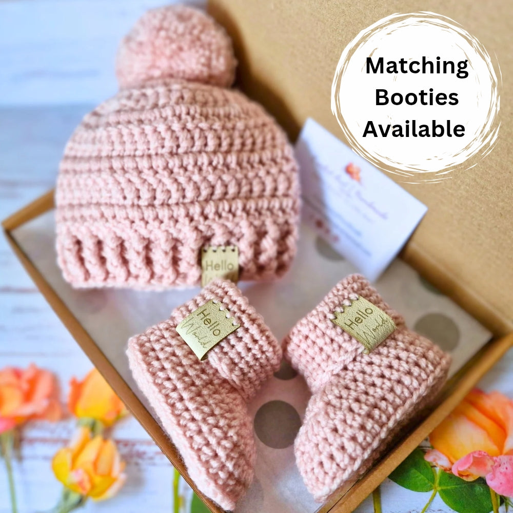 Handmade Hello World Chunky Crochet Pom-Pom Baby Hat – Handmade Winter Beanie – Pom Pom Hat crafted in soft acrylic yarn and available in multiple colours by Twisted by the Sea.