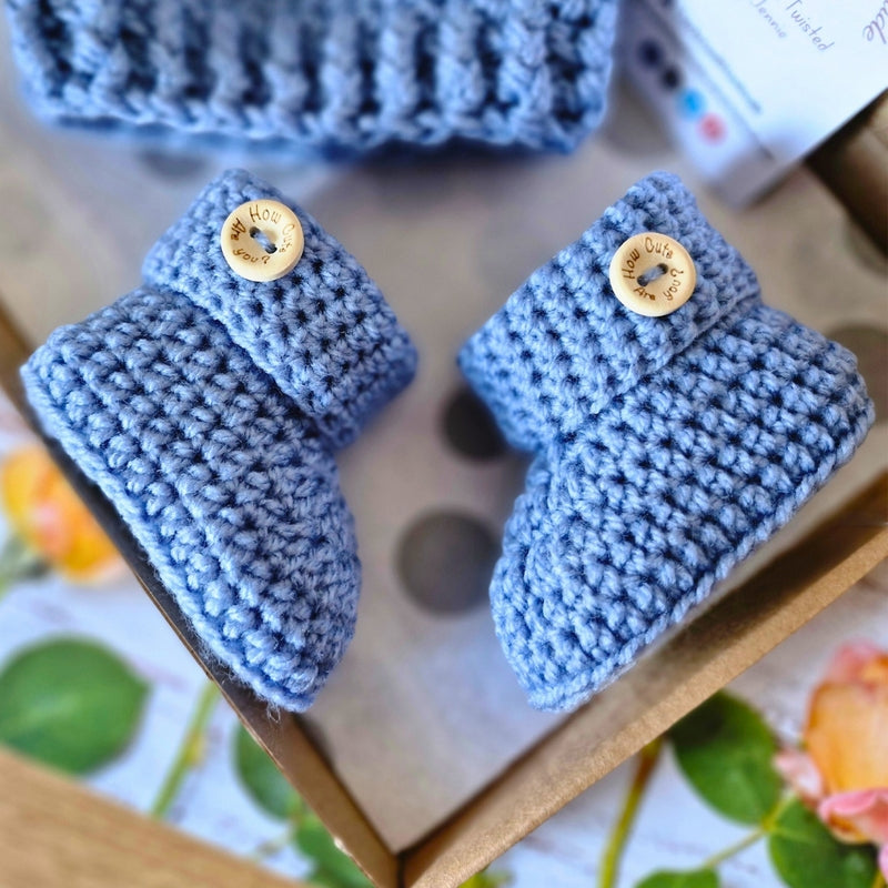Handmade Handmade Crochet Baby Booties with ‘How Cute Are You?’ Wooden Buttons – Baby Booties crafted in soft acrylic yarn and available in multiple colours by Twisted by the Sea.