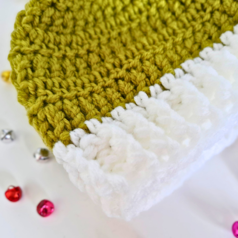 Handmade Handmade Christmas Baby Hat – Mistletoe Green & White Pom Pom Beanie (Newborn to 6 Months) – Pom Pom Hat crafted in soft acrylic yarn and available in multiple colours by Twisted by the Sea.
