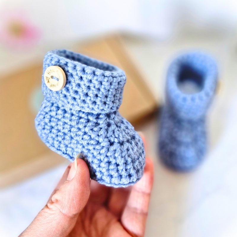 Handmade Handmade Crochet Baby Booties with ‘How Cute Are You?’ Wooden Buttons – Baby Booties crafted in soft acrylic yarn and available in multiple colours by Twisted by the Sea.