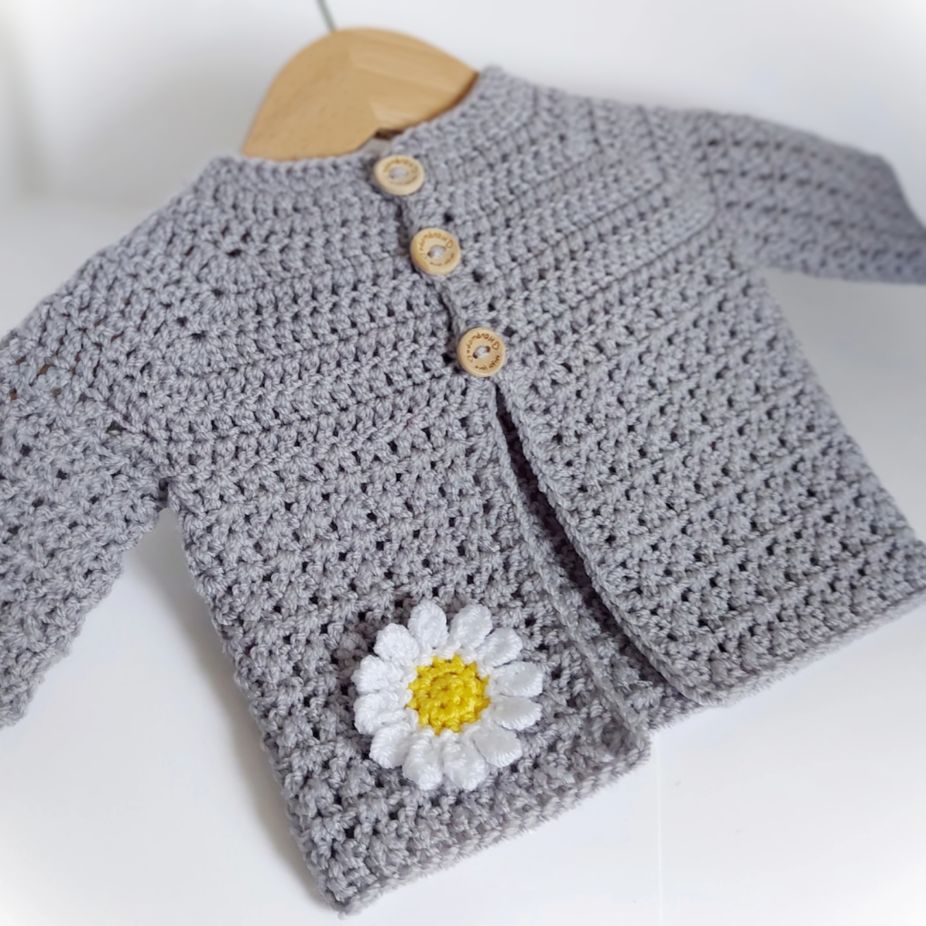 Handmade Crochet Daisy Baby Cardigan – Handmade in sizes 12 to 24 Months – Baby Toddler Cardigans crafted in soft acrylic yarn and available in multiple colours by Twisted by the Sea.