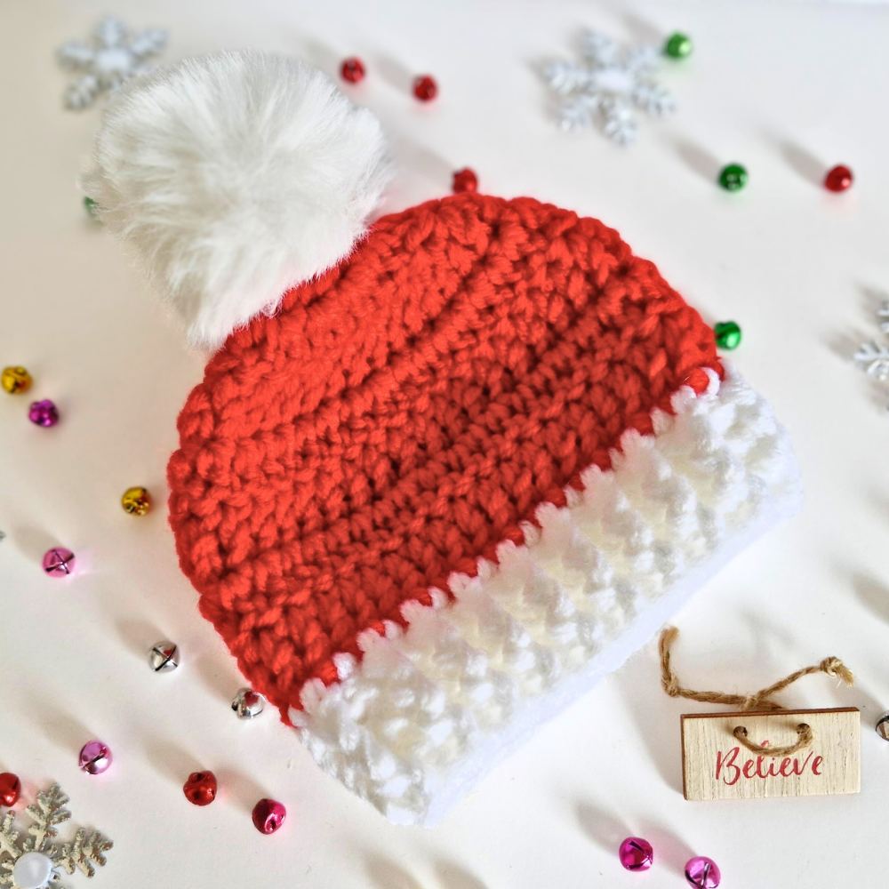 Handmade Handmade Christmas Baby Hat – Red & White Pom Pom Beanie (Newborn to 6 Months) – Pom Pom Hat crafted in soft acrylic yarn and available in multiple colours by Twisted by the Sea.