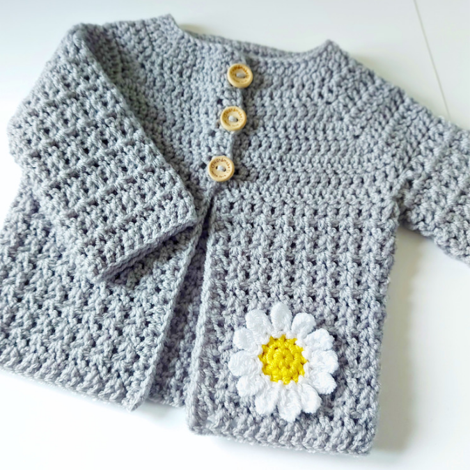 Handmade Crochet Daisy Baby Cardigan – Handmade in sizes 12 to 24 Months – Baby Toddler Cardigans crafted in soft acrylic yarn and available in multiple colours by Twisted by the Sea.