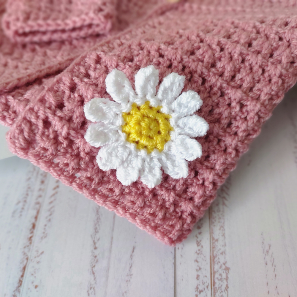 Handmade Crochet Daisy Baby Cardigan – Handmade in sizes 12 to 24 Months – Baby Toddler Cardigans crafted in soft acrylic yarn and available in multiple colours by Twisted by the Sea.