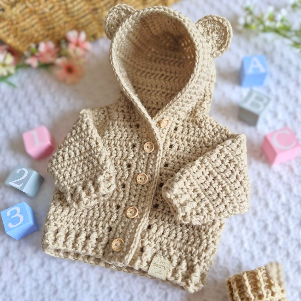 Handmade Crochet Baby Hooded Cardigan – Newborn to 12 Months – Baby Toddler Cardigans crafted in soft acrylic yarn and available in multiple colours by Twisted by the Sea.