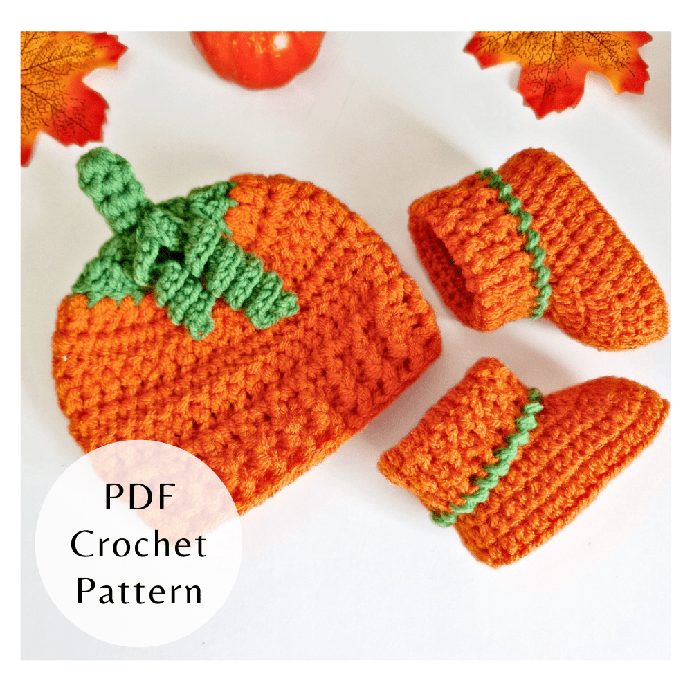 Matching crochet pumpkin baby hat and booties set with green leaf detail. Two-pattern PDF bundle by Twisted by the Sea.