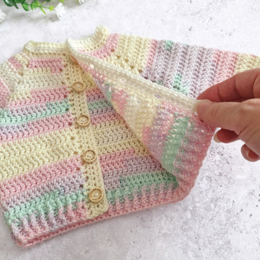 King Cole Beaches Yarn - Baby Cardigan in shade Beaches and Cream