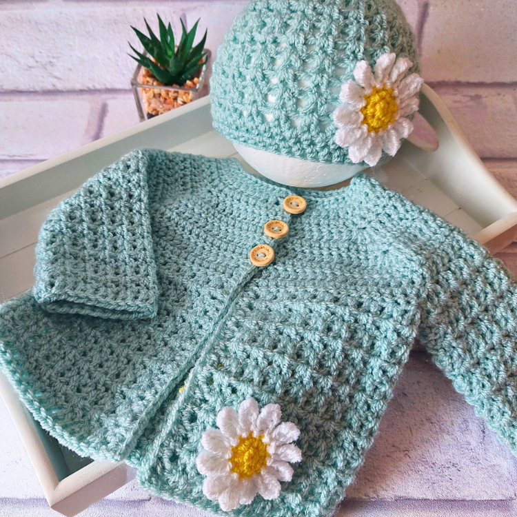 A collection of handmade crochet baby and toddler cardigan and hat sets