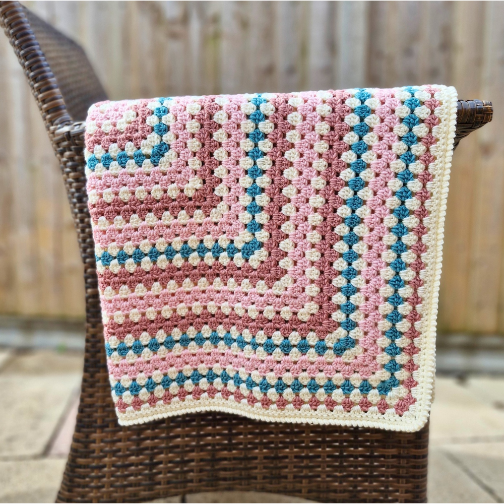 Large handmade crochet granny square baby blanket in teal, pink, and cream by Twisted by the Sea.