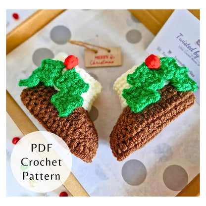 Crocheted Christmas pudding decorations with green holly and red berries on polka dot background