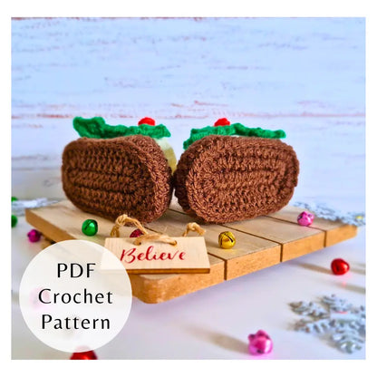 Crochet Christmas pudding slippers with holly decorations on wooden platform with small jingle bells