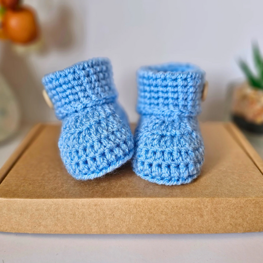 Handmade Born in 2025 Crochet Baby Booties – Handmade Keepsake Gift for Newborns – Baby Booties crafted in soft acrylic yarn and available in multiple colours by Twisted by the Sea.