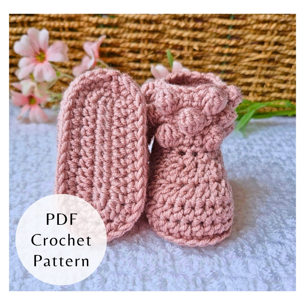 Handmade crochet pattern for bobble baby booties by Twisted by the Sea. Digital PDF download featuring US crochet terms and step-by-step photos. Pictured in pink merino wool.