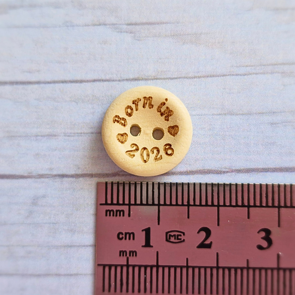 Handmade Born In 2026 Wooden Buttons – 15mm Natural Craft Buttons – Pack of 10, for Sewing, Knitting, Crochet – Buttons crafted in soft acrylic yarn and available in multiple colours by Twisted by the Sea.