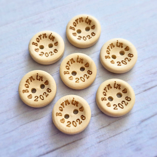 Handmade Born In 2026 Wooden Buttons – 15mm Natural Craft Buttons – Pack of 10, for Sewing, Knitting, Crochet – Buttons crafted in soft acrylic yarn and available in multiple colours by Twisted by the Sea.