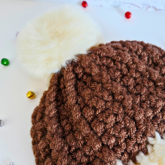 Handmade Christmas Pudding Baby Hat – Handmade Crochet Pom Pom Hat – Pom Pom Hat crafted in soft acrylic yarn and available in multiple colours by Twisted by the Sea.