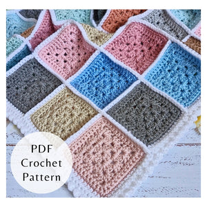 Patchwork granny square baby blanket with white seams and border. A stash busting crochet PDF pattern by Twisted by the Sea.