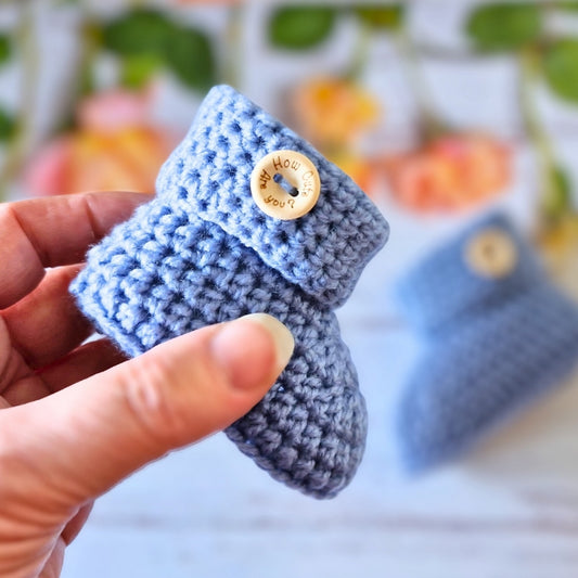 Handmade Handmade Crochet Baby Booties with ‘How Cute Are You?’ Wooden Buttons – Baby Booties crafted in soft acrylic yarn and available in multiple colours by Twisted by the Sea.