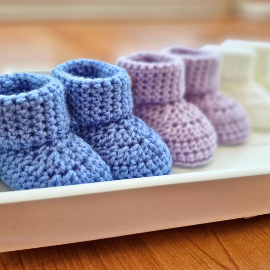 Handmade Handmade Crochet Baby Booties with ‘How Cute Are You?’ Wooden Buttons – Baby Booties crafted in soft acrylic yarn and available in multiple colours by Twisted by the Sea.