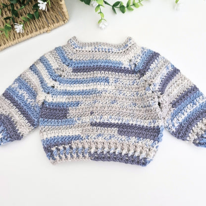Back view of a vaby cardigan in shades of blue and silver