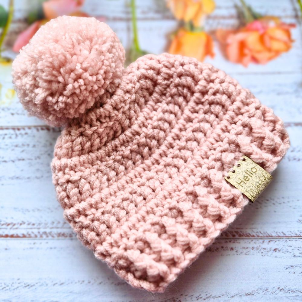 Handmade Hello World Chunky Crochet Pom-Pom Baby Hat – Handmade Winter Beanie – Pom Pom Hat crafted in soft acrylic yarn and available in multiple colours by Twisted by the Sea.