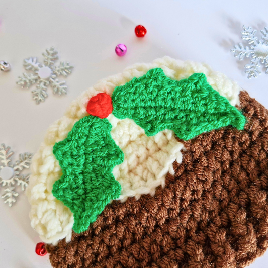 Handmade Christmas Pudding Baby Hat with Holly & Berry – Beanie Hat crafted in soft acrylic yarn and available in multiple colours by Twisted by the Sea.