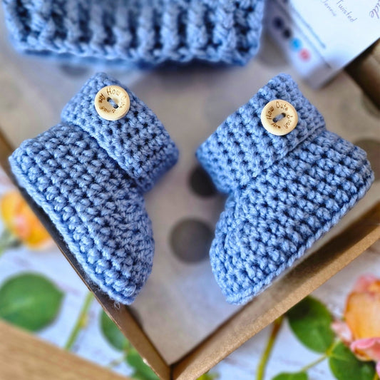 Handmade Handmade Crochet Baby Booties with ‘How Cute Are You?’ Wooden Buttons – Baby Booties crafted in soft acrylic yarn and available in multiple colours by Twisted by the Sea.