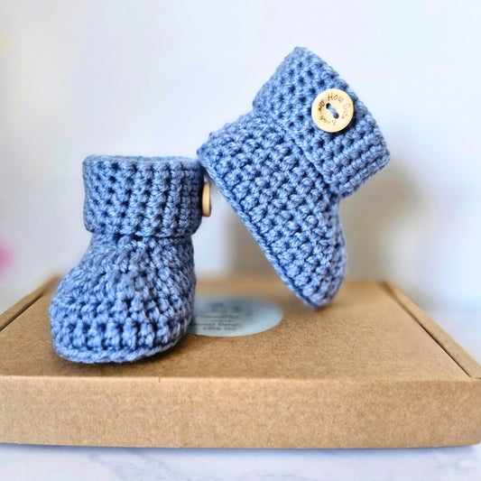 Handmade Handmade Crochet Baby Booties with ‘How Cute Are You?’ Wooden Buttons – Baby Booties crafted in soft acrylic yarn and available in multiple colours by Twisted by the Sea.