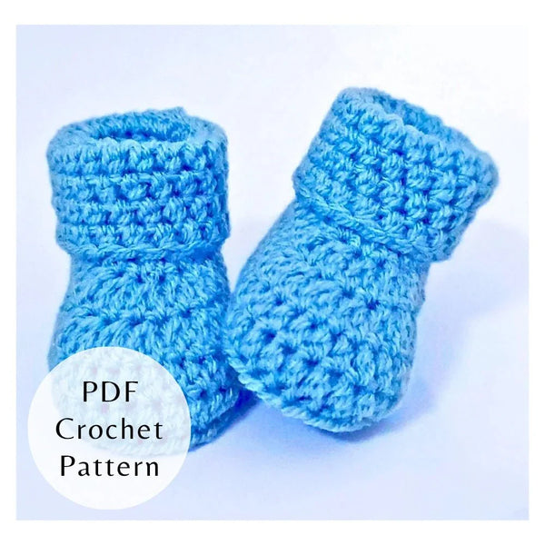 Cosy handmade crochet baby booties with a folded cuff. Beginner friendly three-size PDF pattern by Twisted by the Sea.