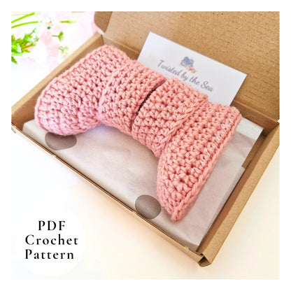 Pink crochet pattern in a box with a brand label