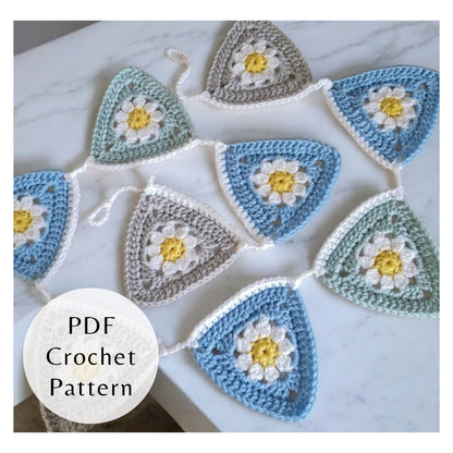 Crocheted triangle patterns with floral designs on a marble surface, labeled 'PDF Crochet Pattern'.