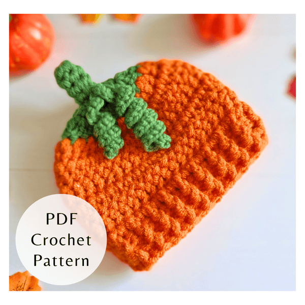 Textured orange crochet pumpkin baby hat with a green stalk. Three-size autumn PDF pattern by Twisted by the Sea, digital.