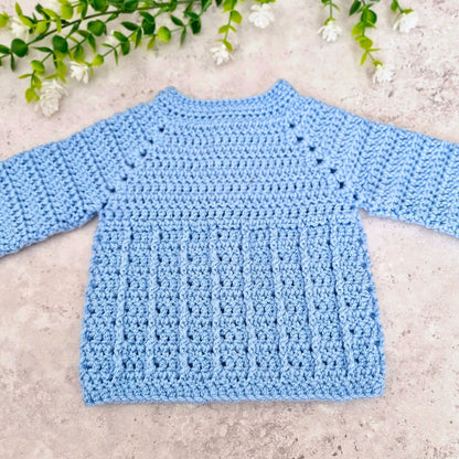 A back view of the textured crochet baby blue cardigan 