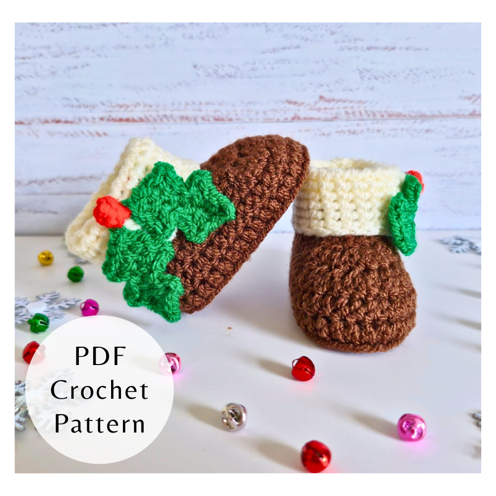 Handmade crochet Christmas baby booties with holly leaf detail and cream cuffs. Festive PDF pattern by Twisted by the Sea.